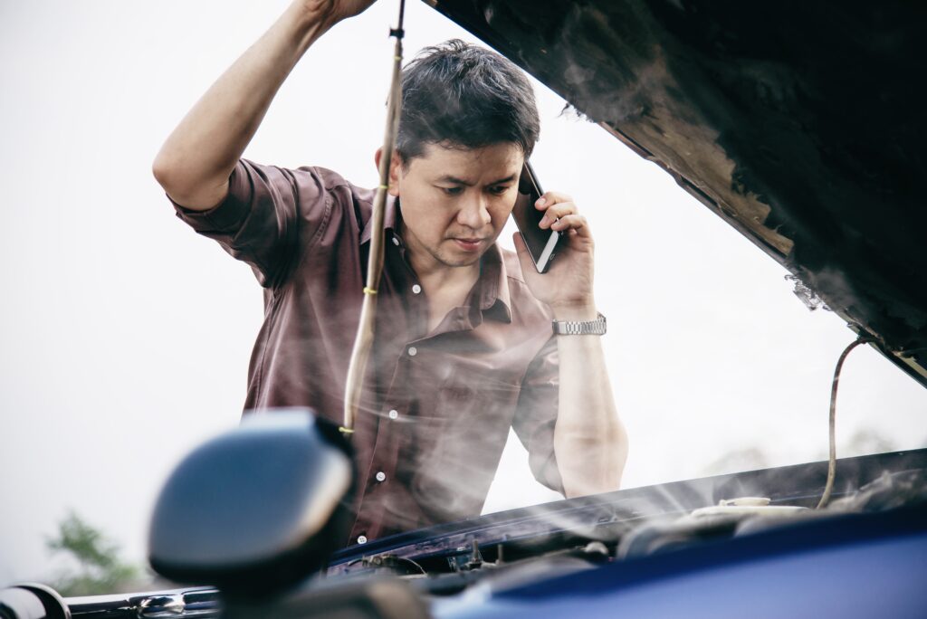 man-try-fix-car-engine-problem-local-road